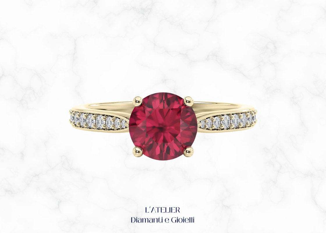 Anello di fidanzamento in Oro 18kt con Rubino Naturale rotondo in castone a griffe e Diamanti Naturali incastonati a pavé sul gambo.