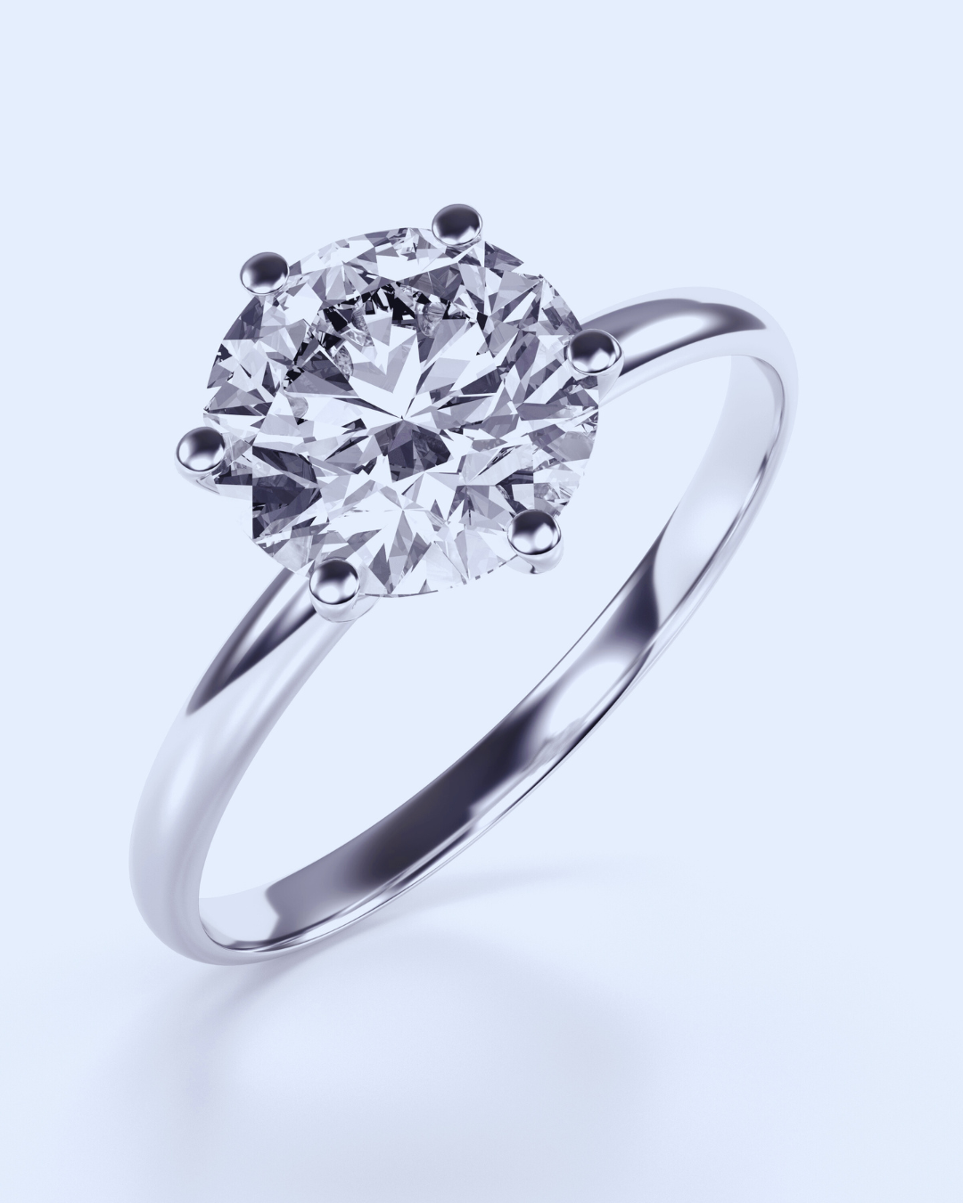 Anello solitario classico in oro bianco con grande diamante rotondo brillante incastonato a sei griffe, su sfondo chiaro. Simbolo di eleganza e amore eterno, gioiello ideale per fidanzamento da Atelier Diamanti a Roma.
