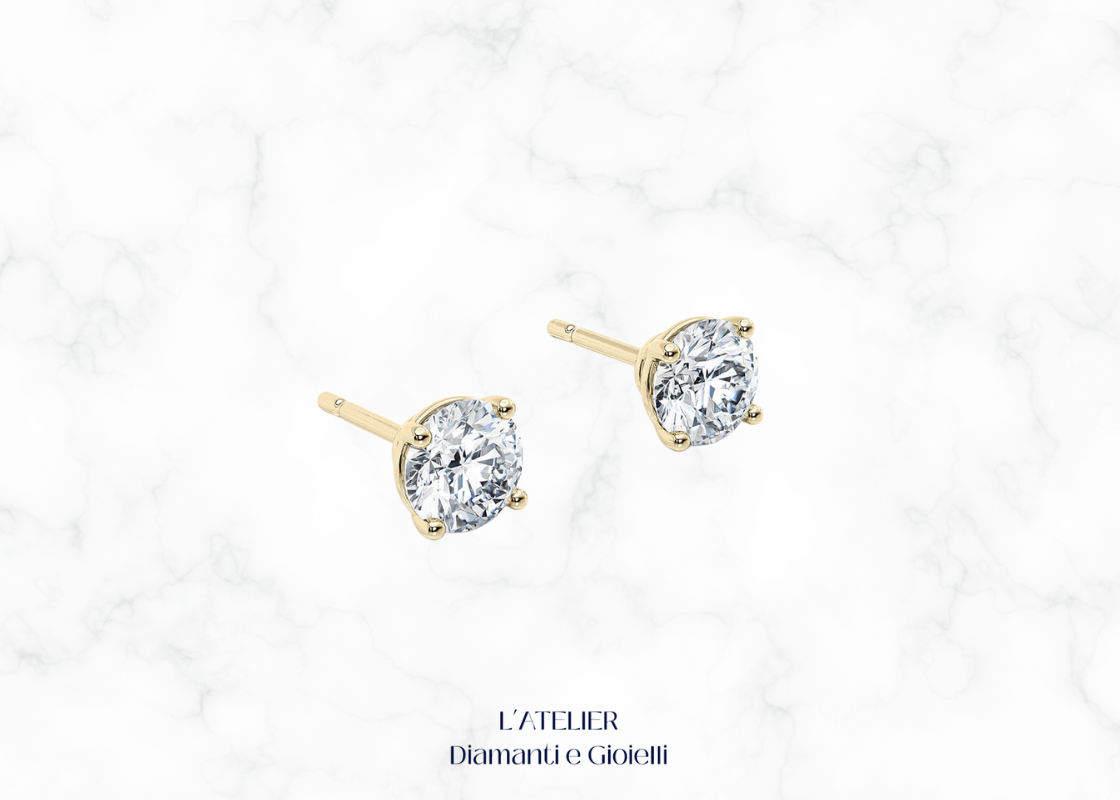 Primo piano sulla montatura a griffe di orecchini punto luce diamante Colore F Purezza VS1. Dettaglio gioiello oro 18k.

