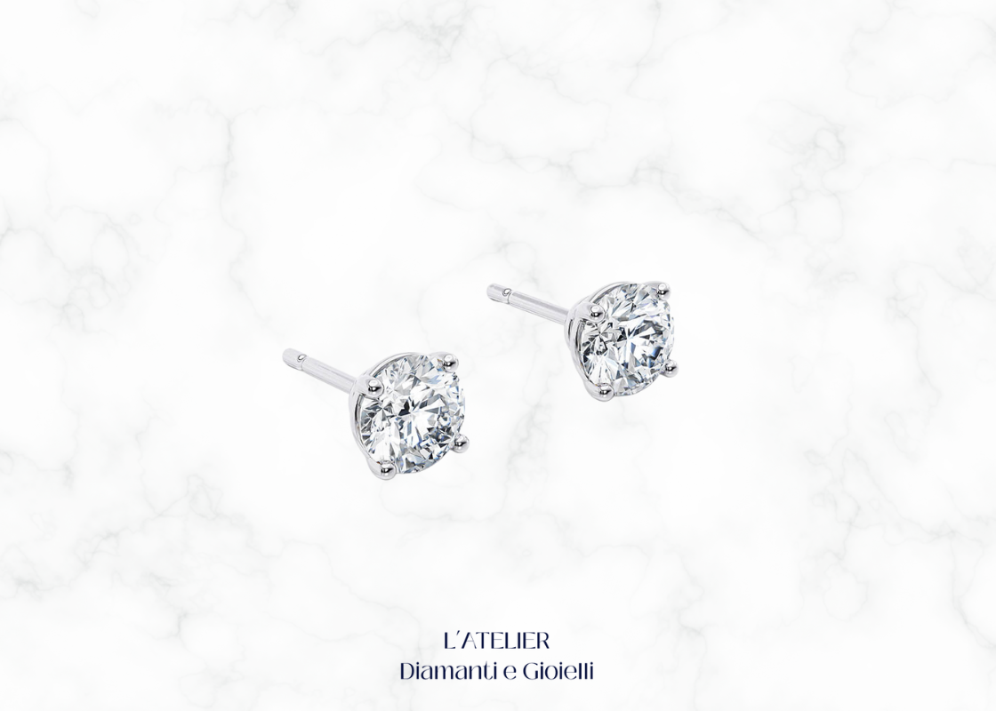 Primo piano sulla montatura a griffe di orecchini punto luce diamante Colore F Purezza VS1. Dettaglio gioiello oro 18k.

